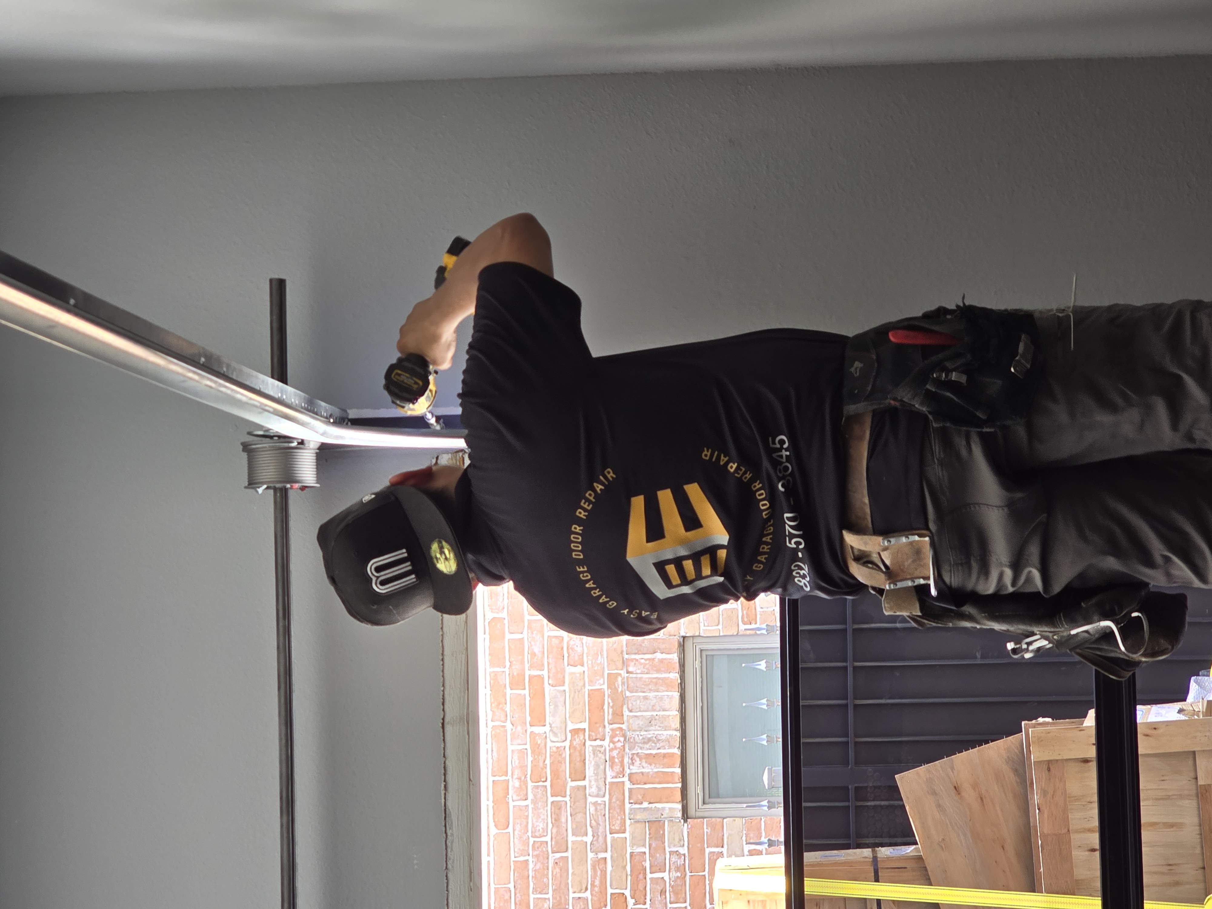 Licensed technician diagnosing garage door problem