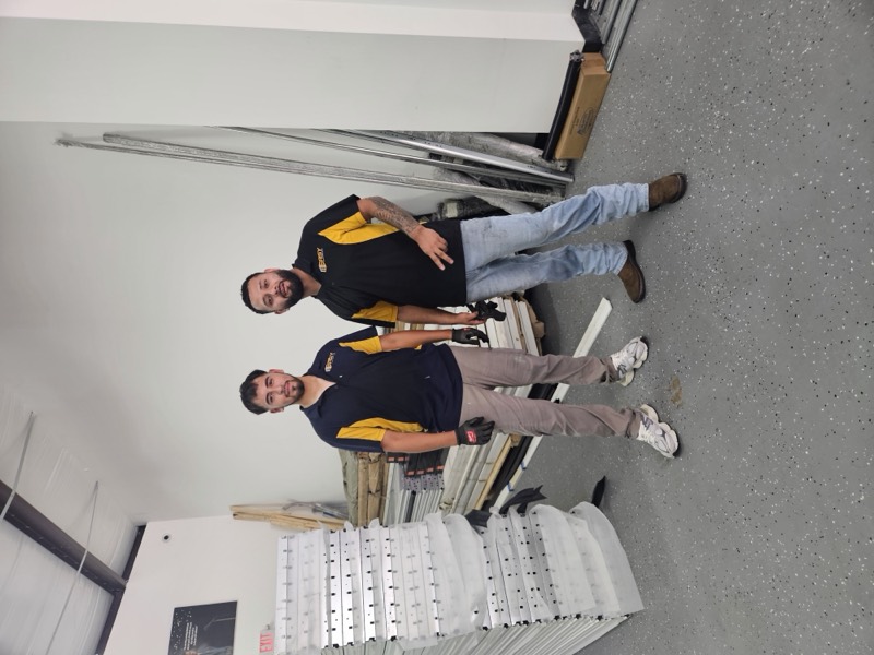 Two Easy techs at the warehouse with new garage door panels